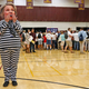 A Trump supporter wears a Hillary Clinton mask and prison jumpsuit at a campaign rally in Tempe, Arizona on Oct. 27, 2016. (Image via AP Photo/Ross D. Franklin).